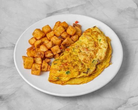 Masala Omelette — spiced three-egg omelette with onions, tomatoes and herbs served with home fries at Sunny Side Up Sherwood Park